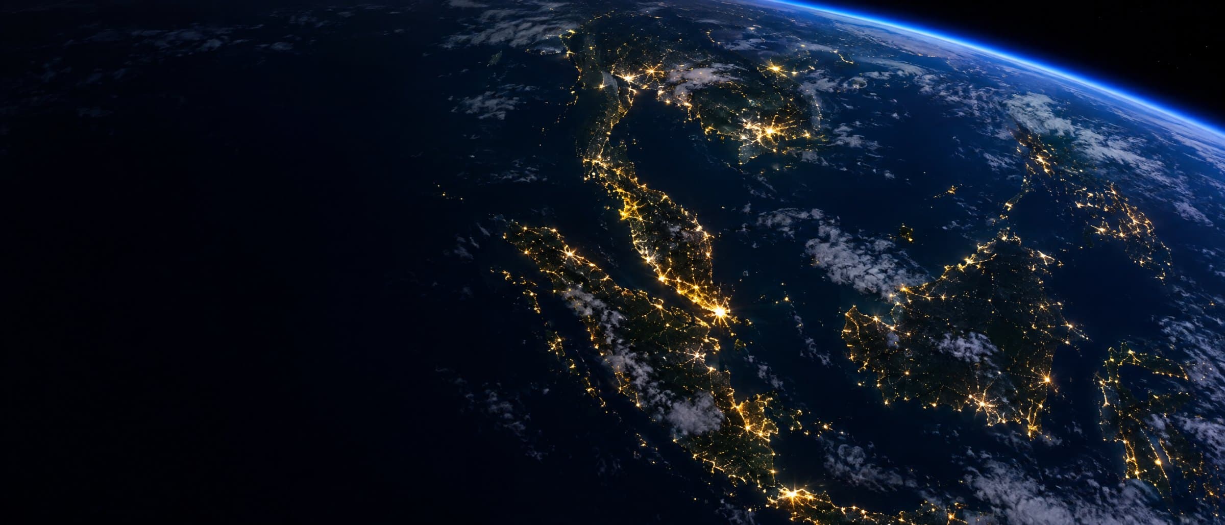 Southeast Asia at night seen from orbit, with city lights below